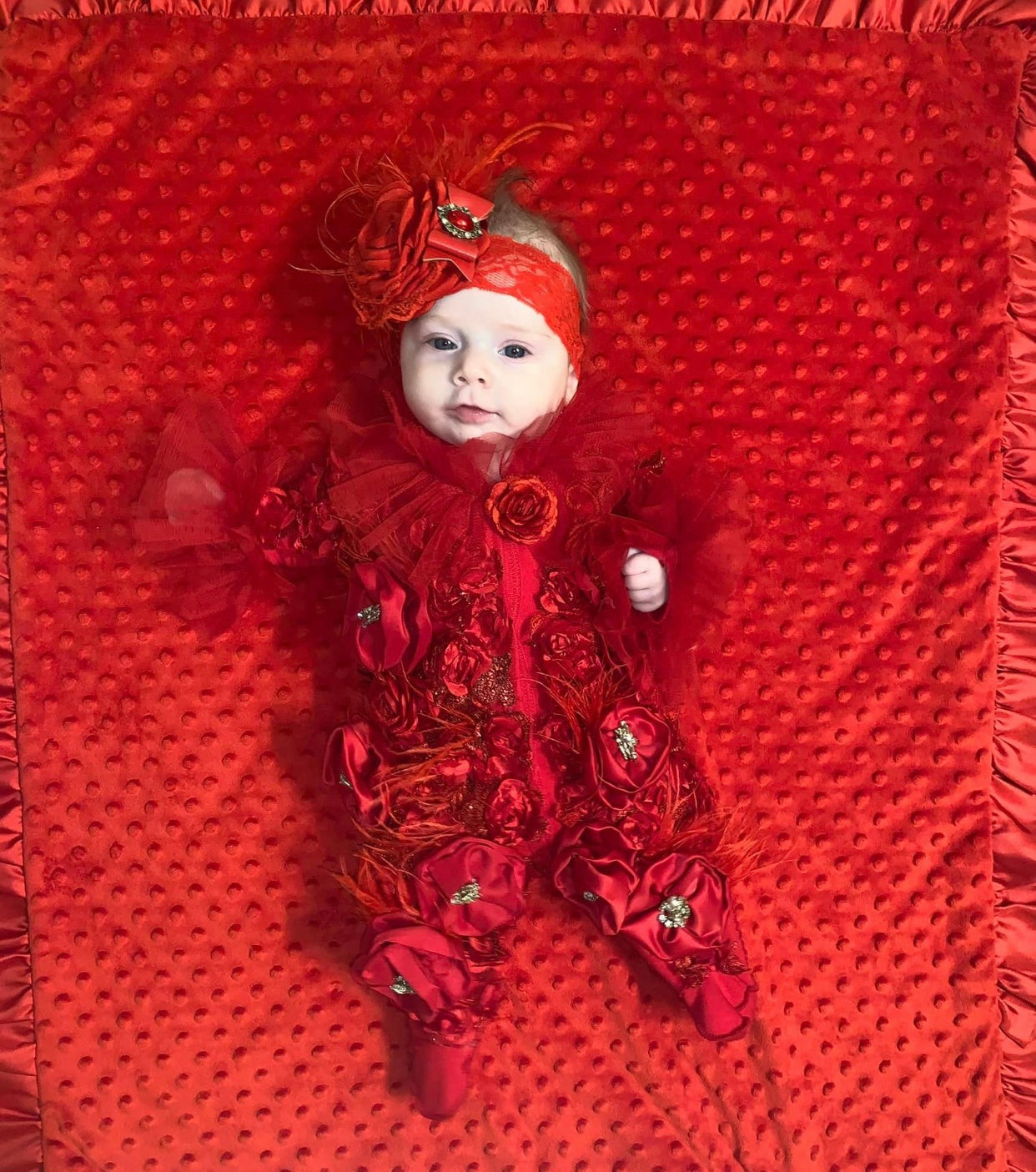 red baby jumpsuit flowers and bonnet